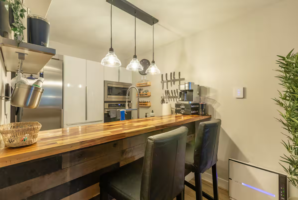 Fully equipped modern kitchen with bar seating at 11 Emmons ski in ski out property