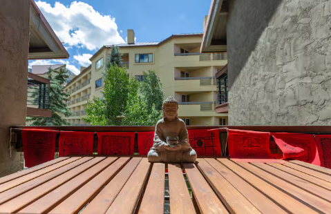 Sunny outdoor deck with red seating and ski slope views at 11 Emmons Road